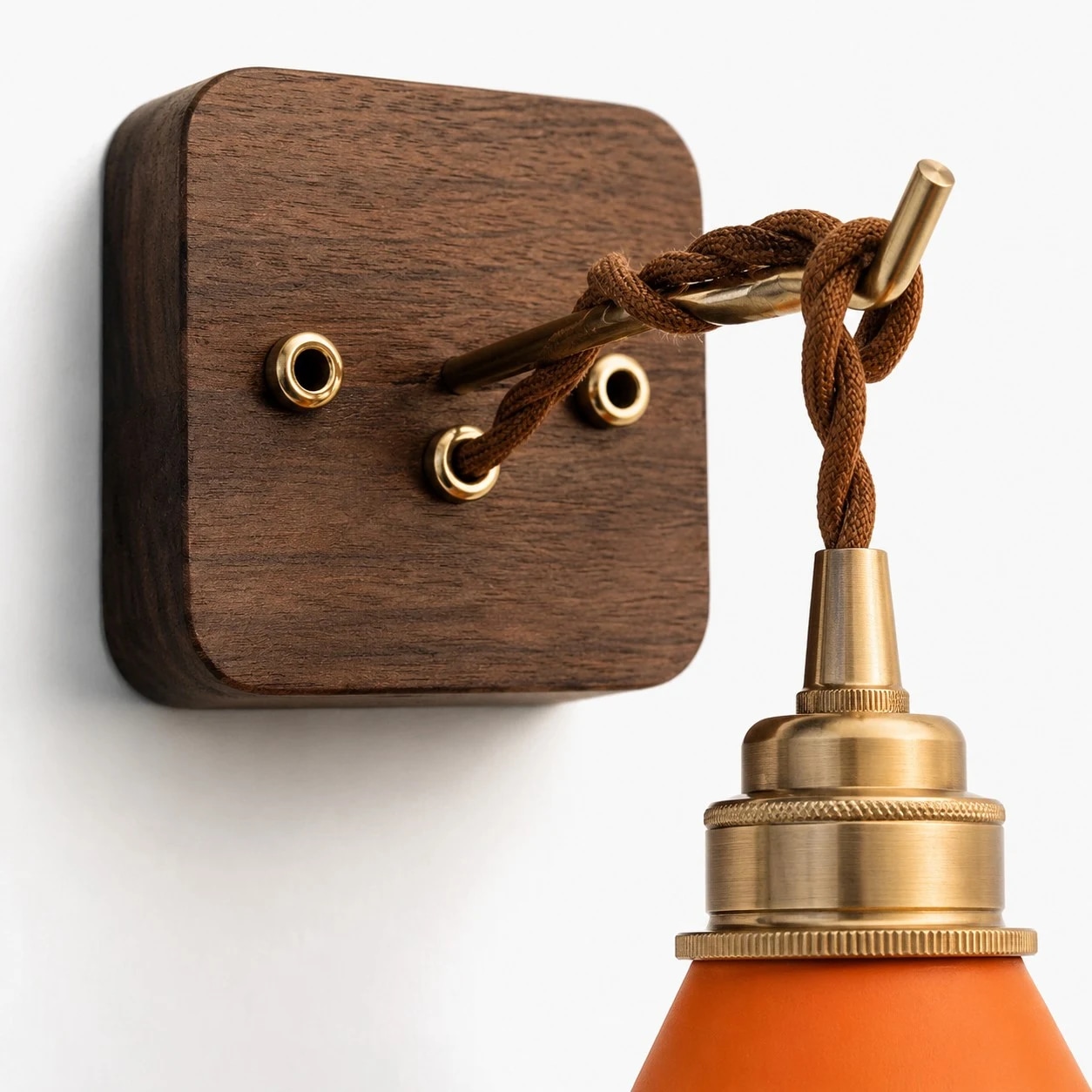 Close view of the wood wall base, cord guide, brass collar, and leather shade