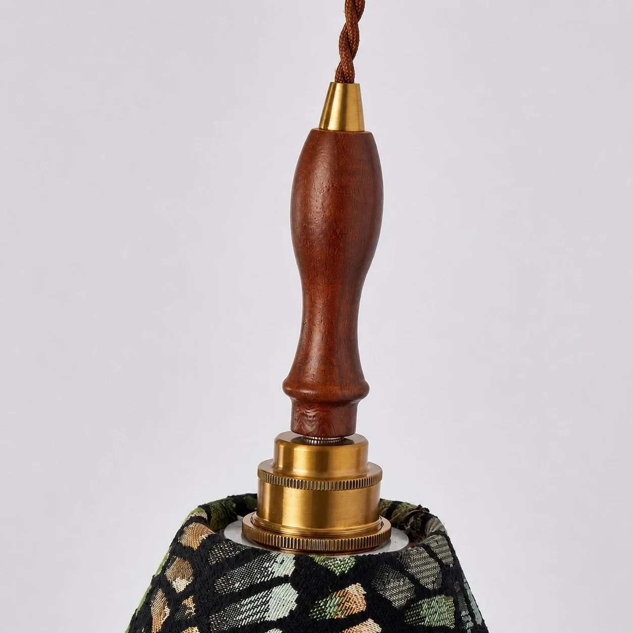 Wood handle and brass-tone holder detail