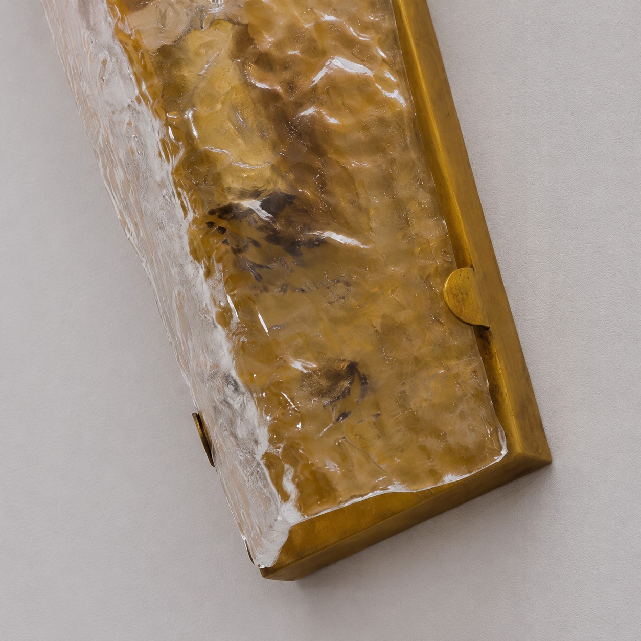 Close detail of clear textured glass and copper frame