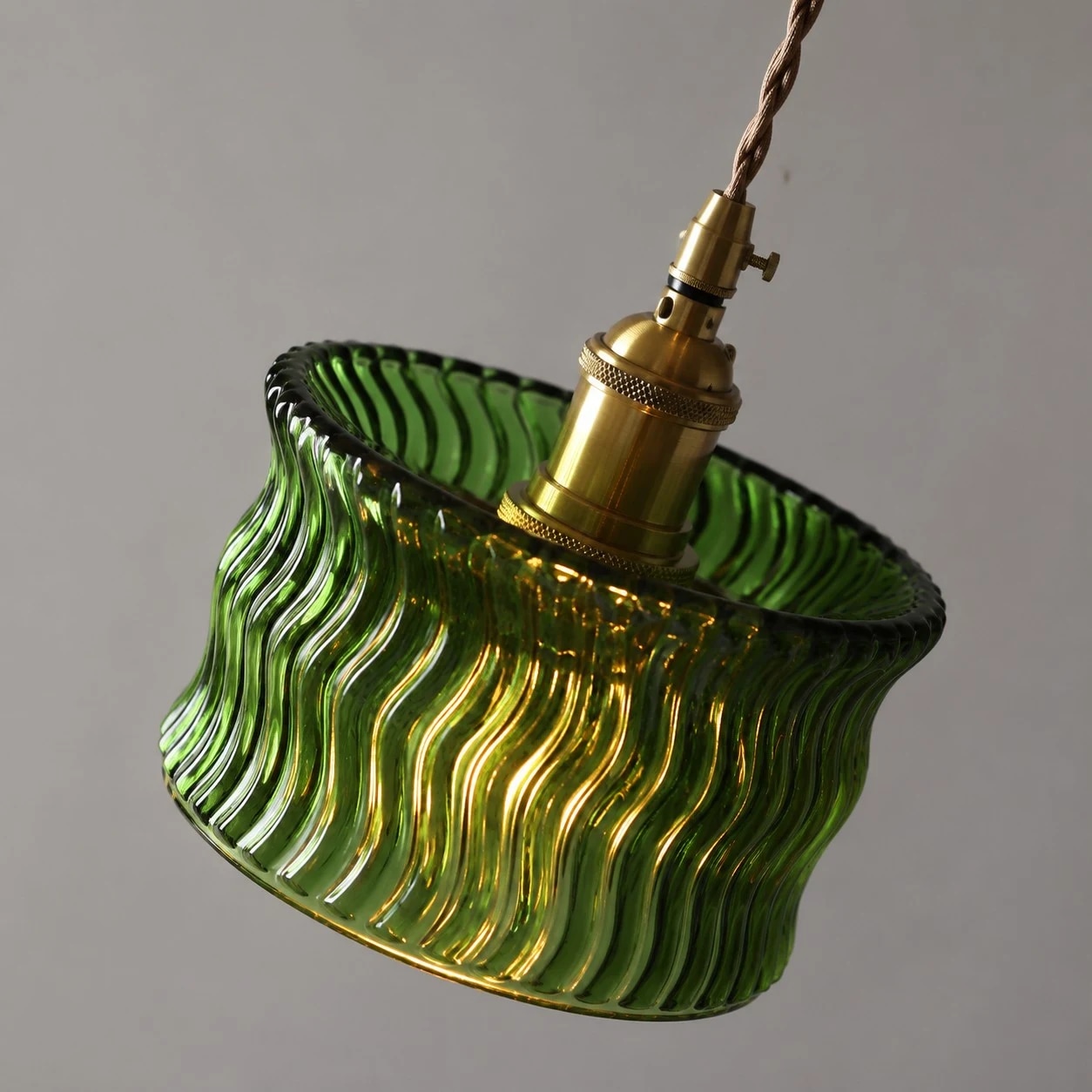 Angled view of the green ripple glass shade and adjustable cord