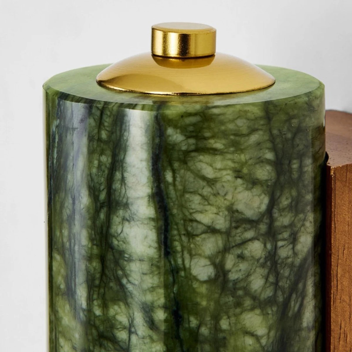 Green jade cylinder texture and brass metal cap close up