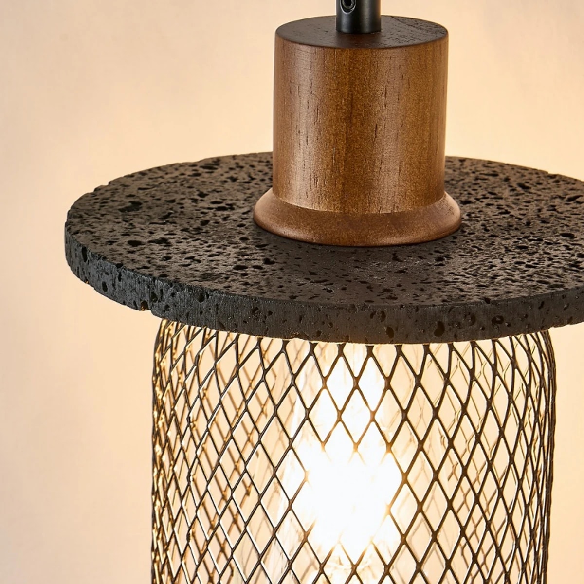 Close view of black travertine rim and woven metal pendant shade