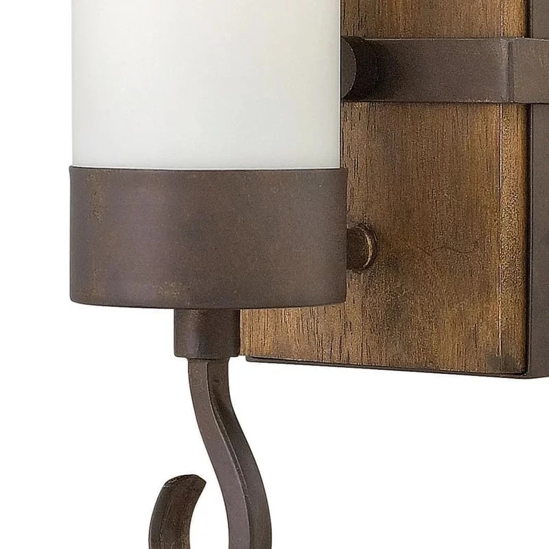 Close view of the wood grain, dark metal cup, and curved candle-style arm