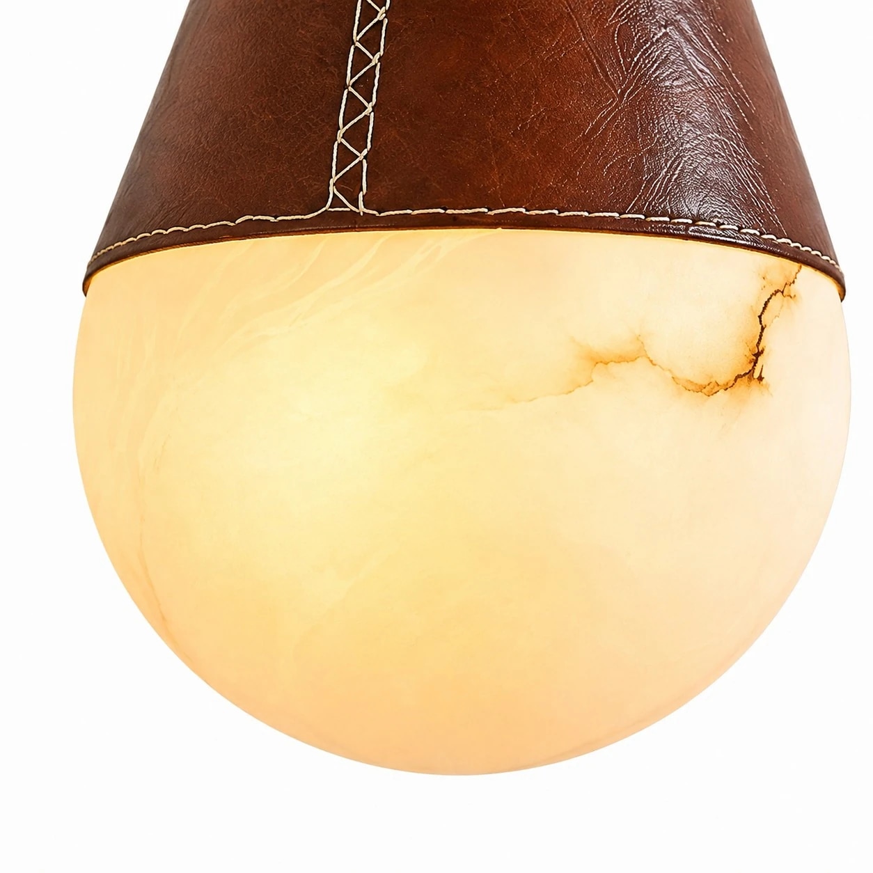 Warm ivory faux marble globe diffuser glowing softly