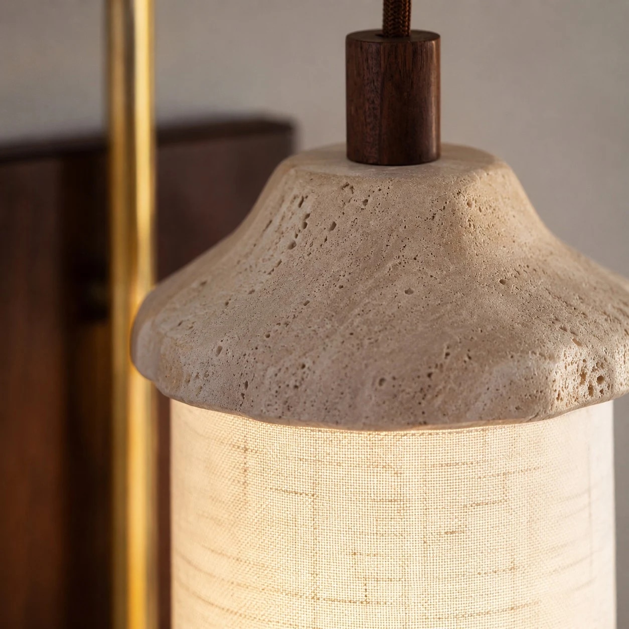 Close view of travertine cap and fabric shade