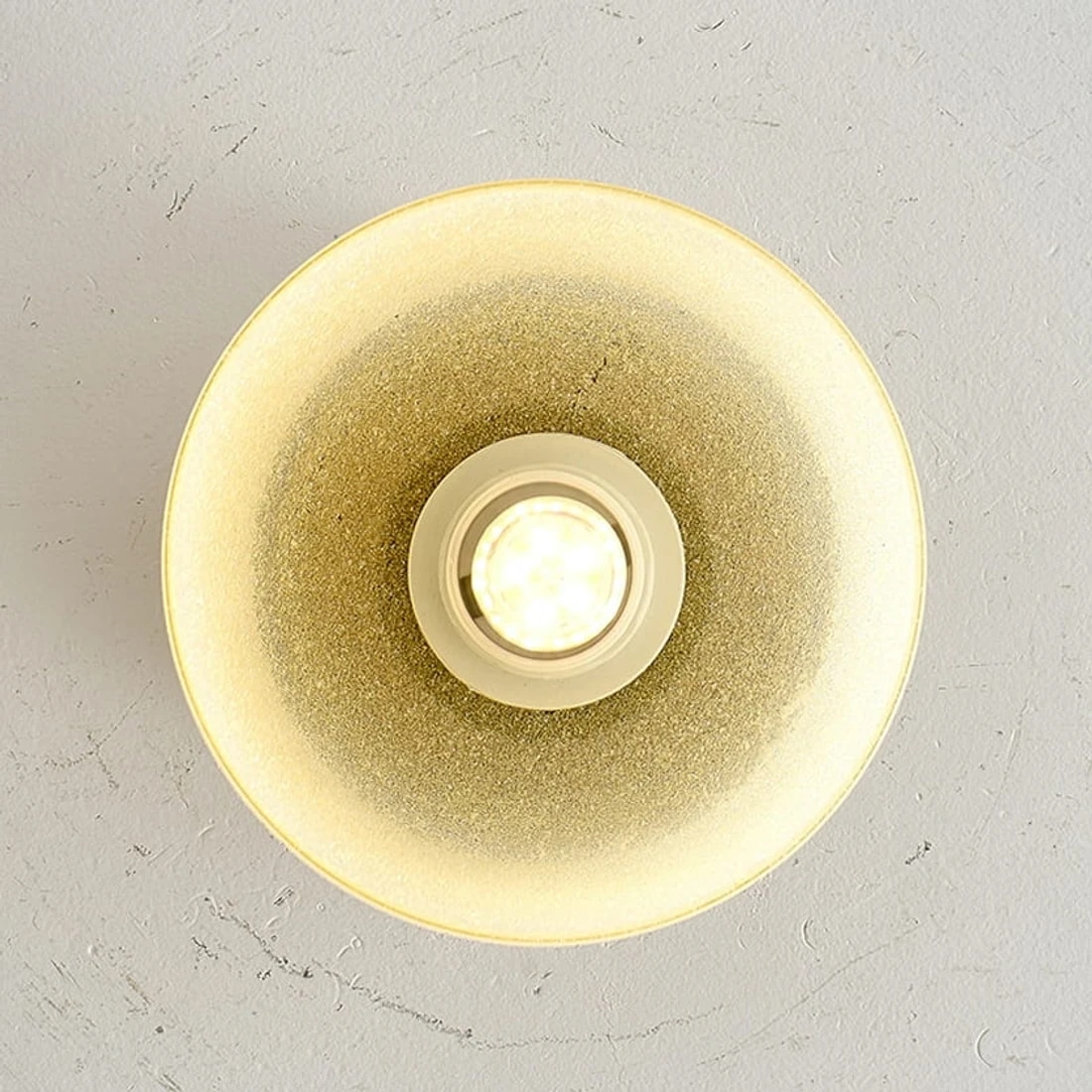 Warm glow detail inside the yellow glass shade