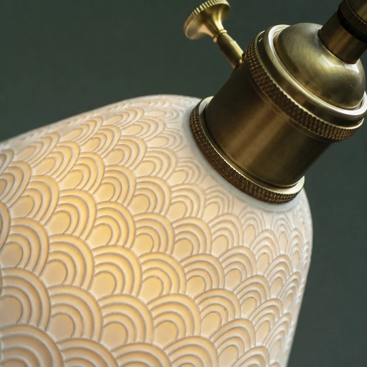 Brass socket and raised ceramic texture detail