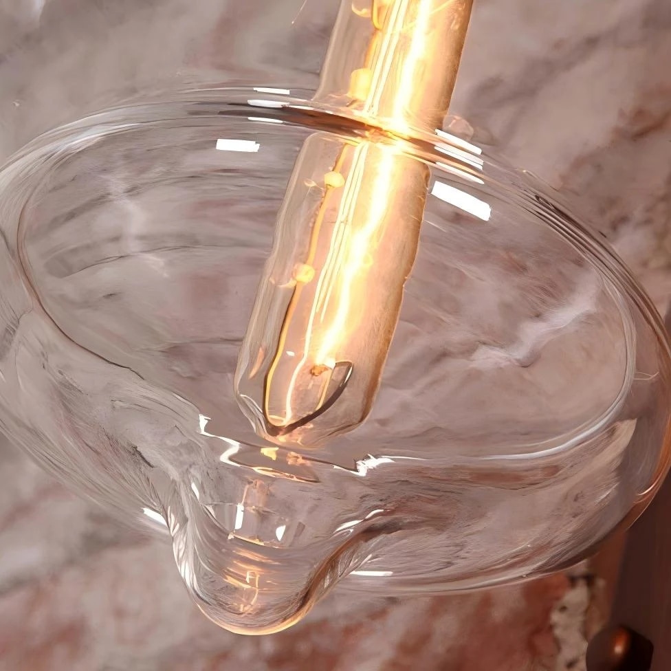 Clear glass shade and warm bulb glow detail