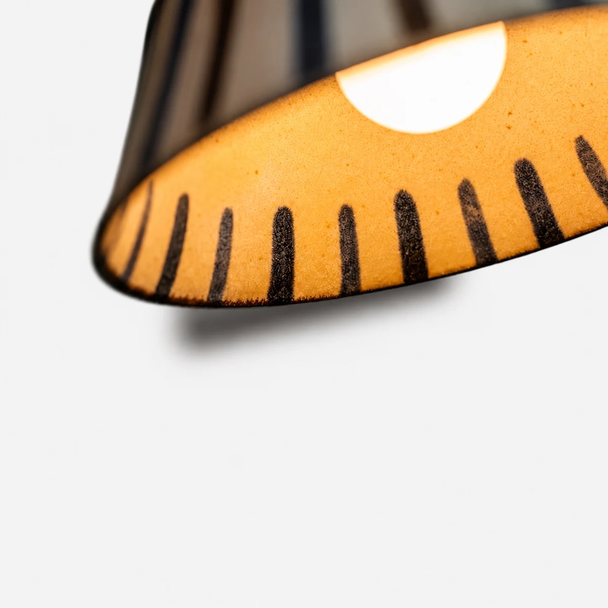 Warm glow from the ceramic shade interior