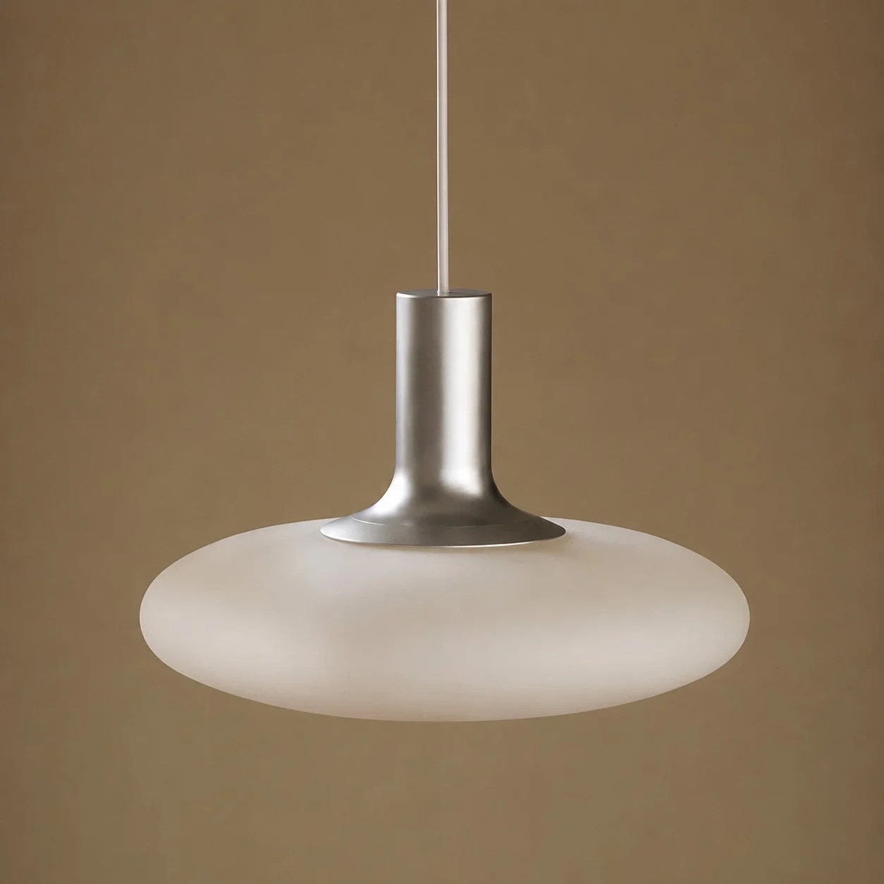 Close view of white glass shade and chrome metal pendant neck