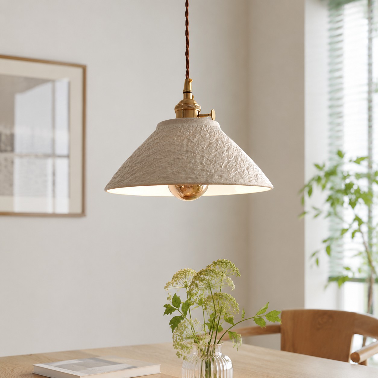 Single ceramic pendant light over a dining table