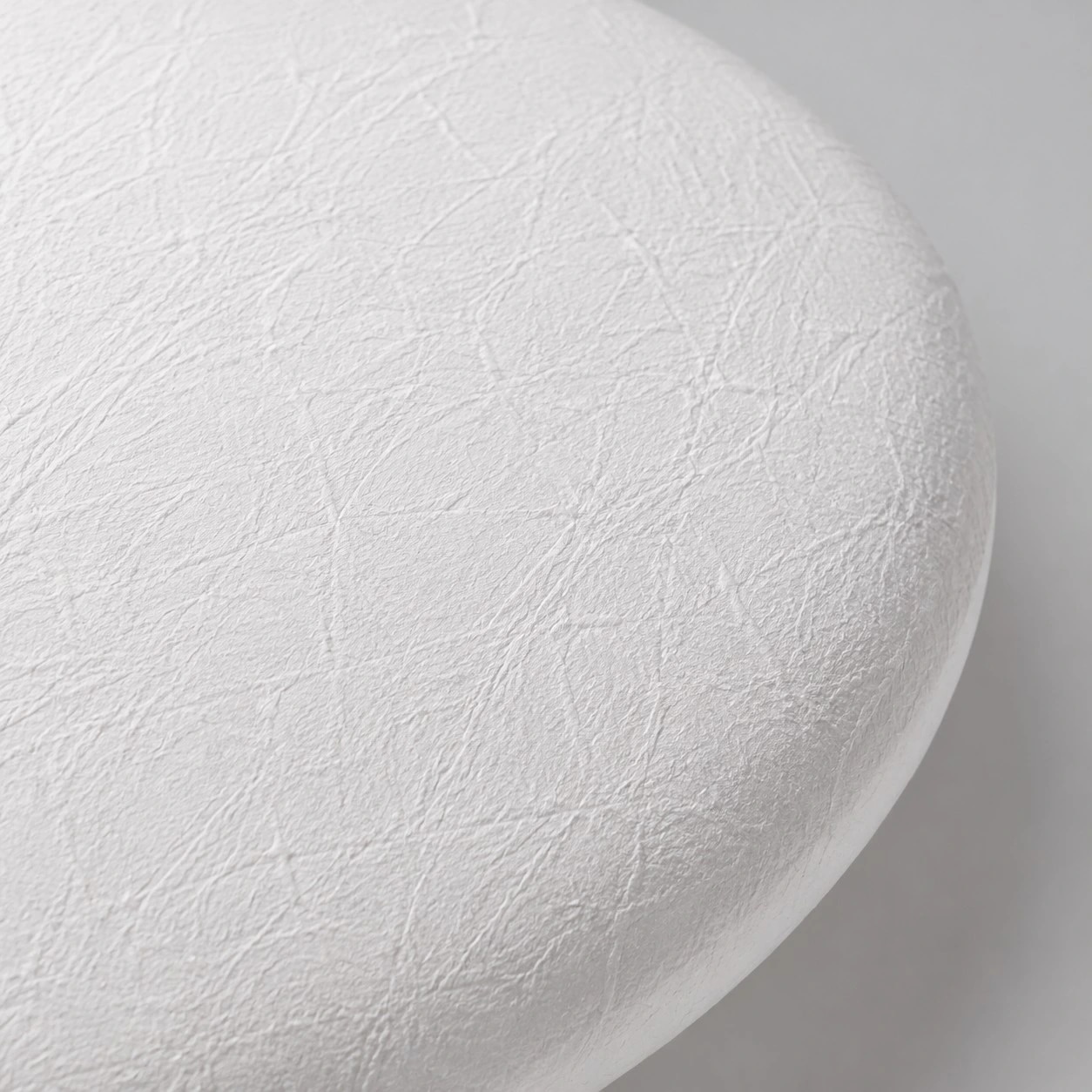 Close view of the textured white resin shade and rounded edge