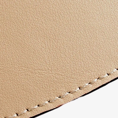 Close-up of leather texture and stitched pendant shade edge