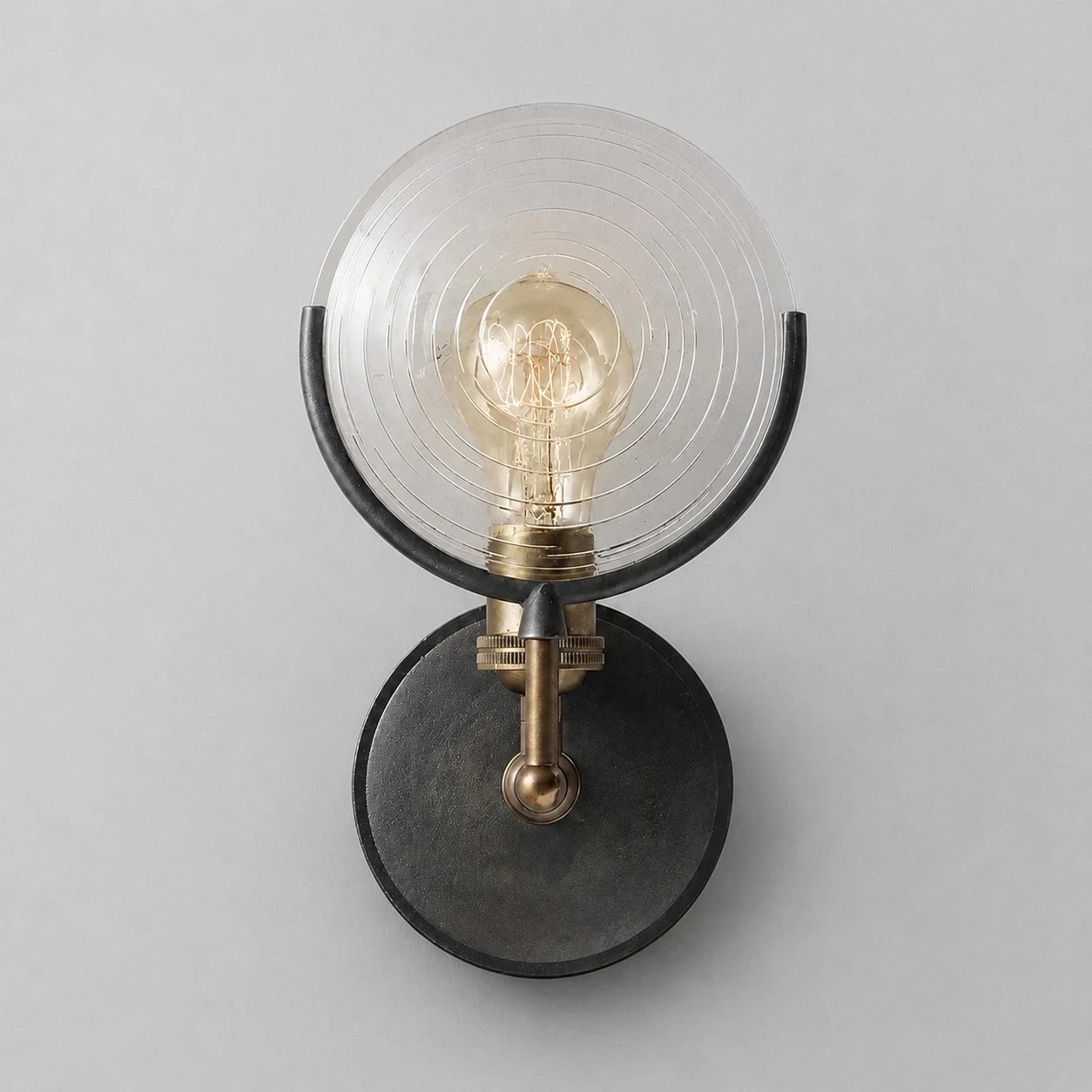 Front detail of glass shade and round backplate