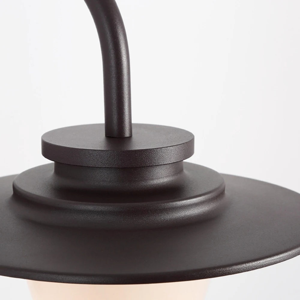 Close view of the coffee brown curved metal arm