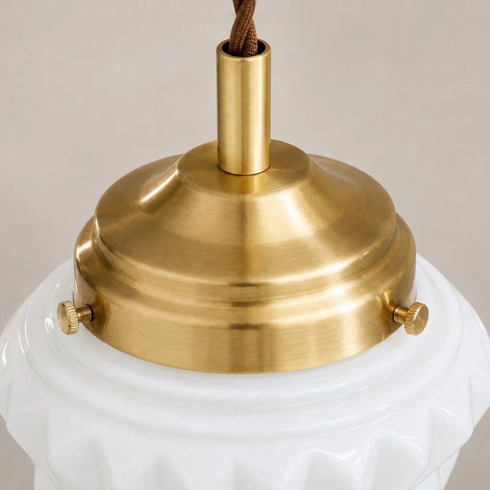 Brass finish ceiling cap and milk glass pendant detail