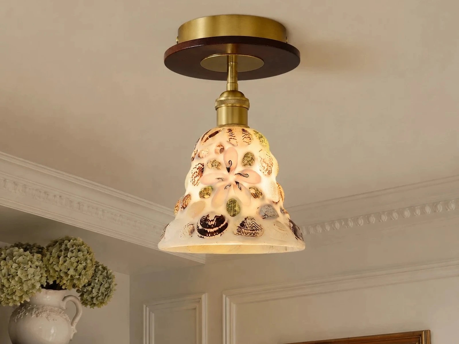 Shell glass flush mount ceiling light installed in a hallway