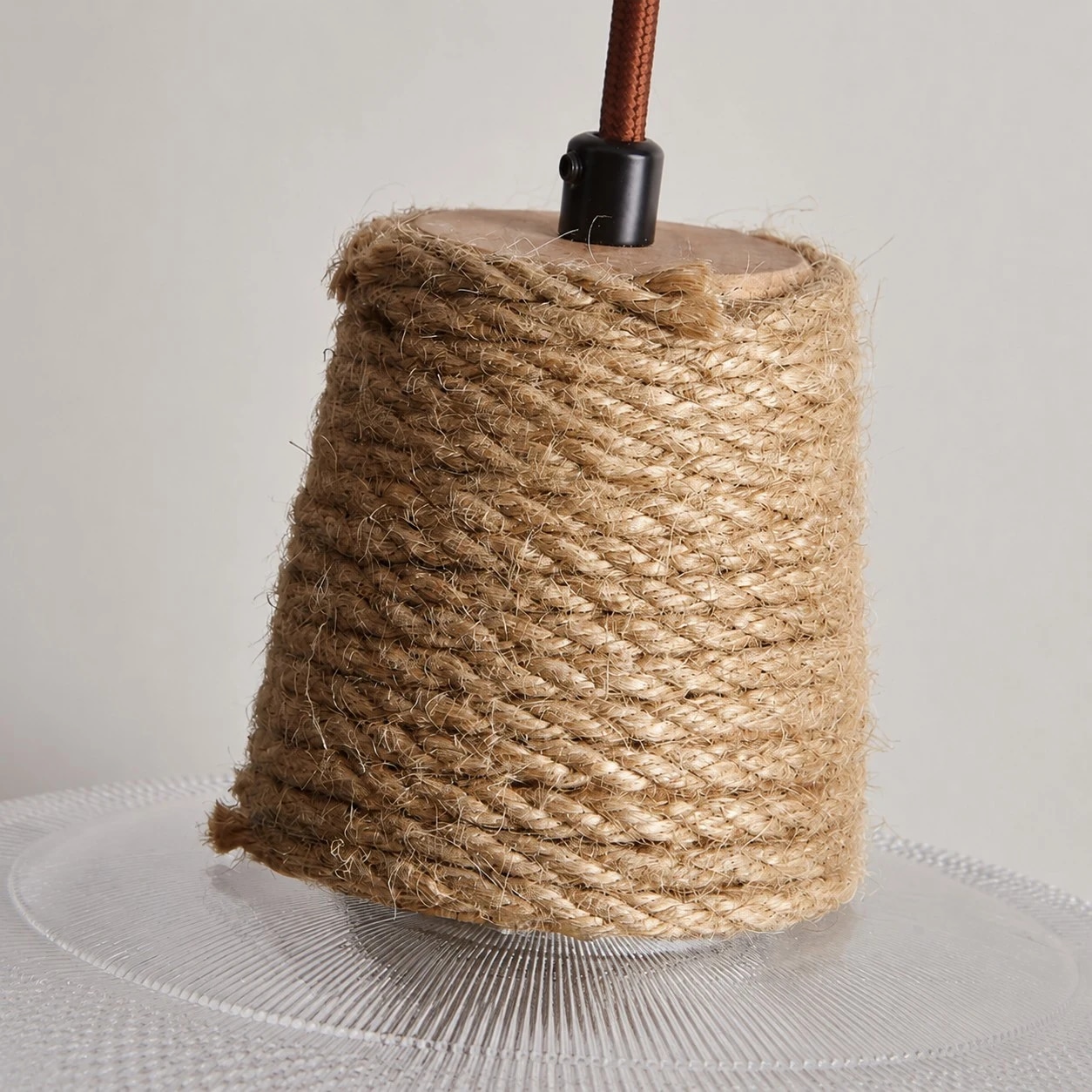 Close detail of woven rope collar and brown suspension cord