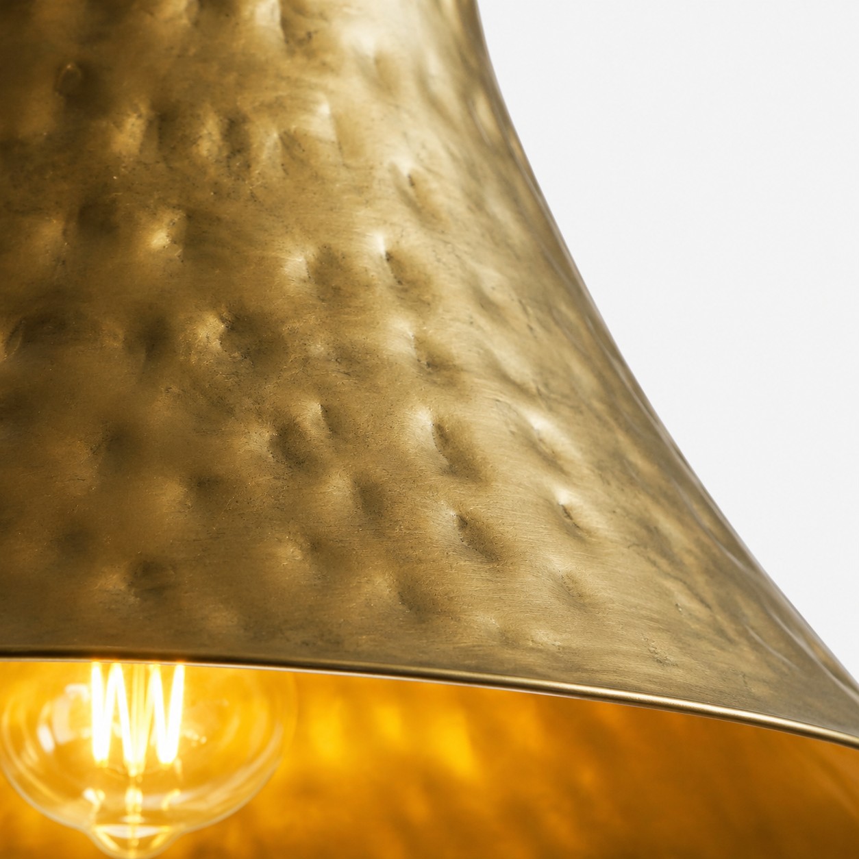 Hammered brass pendant with bulb close-up
