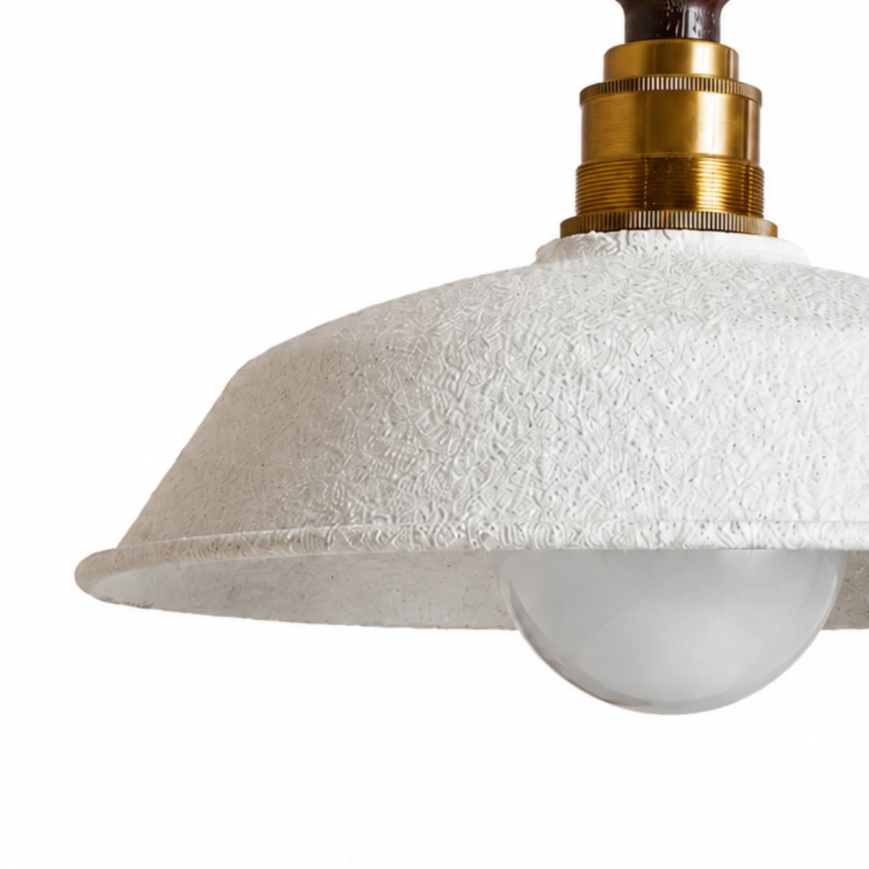 Close view of the white textured metal shade and brass-toned socket