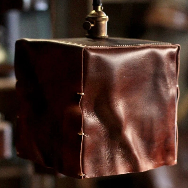 Close view of brown hand-shaped leather pendant shade