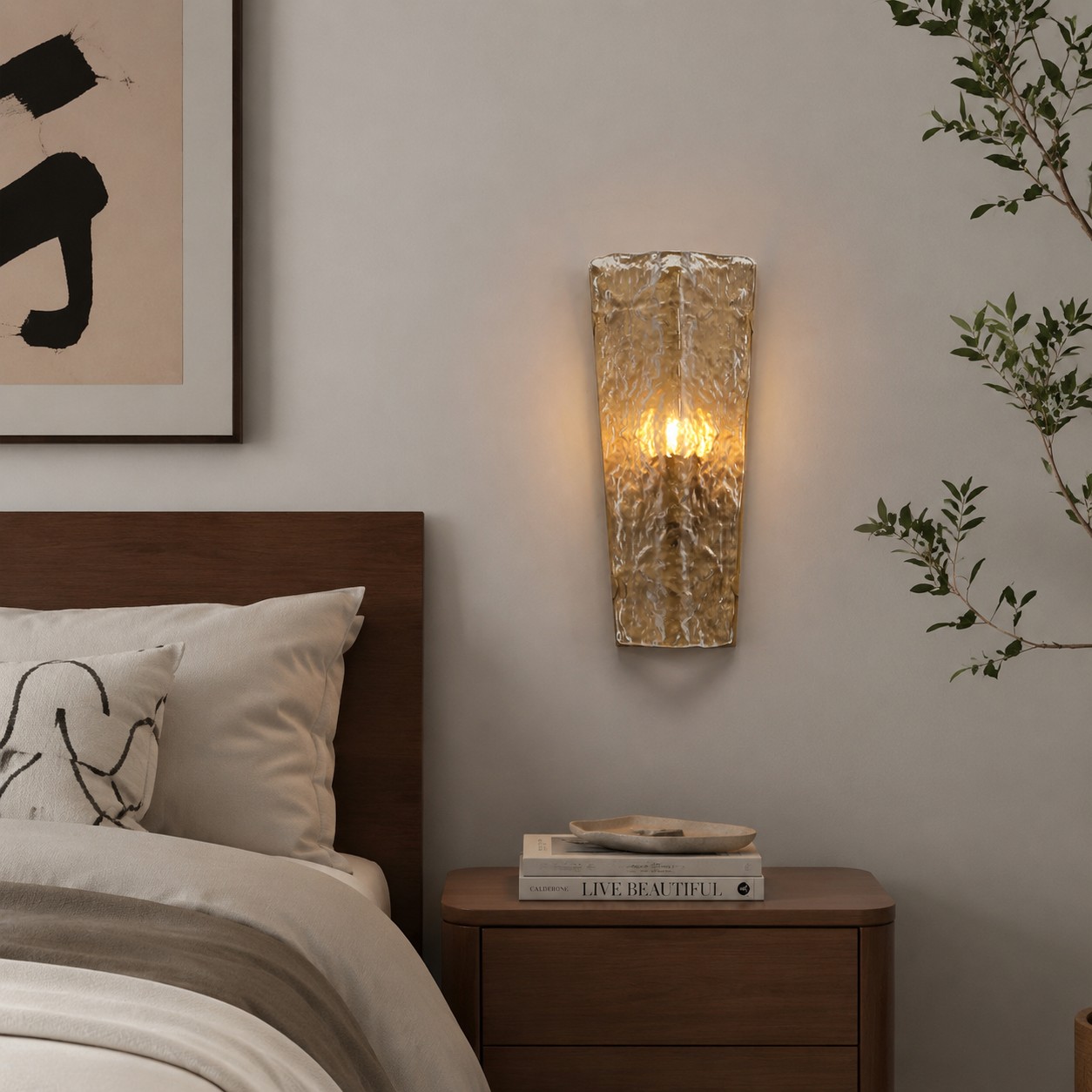 Clear glass wall lamp installed beside a bedroom nightstand