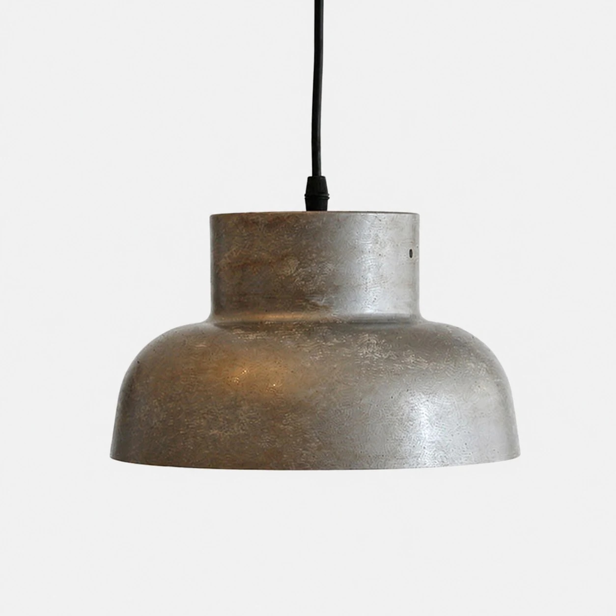 Aged metal industrial pendant light on plain background