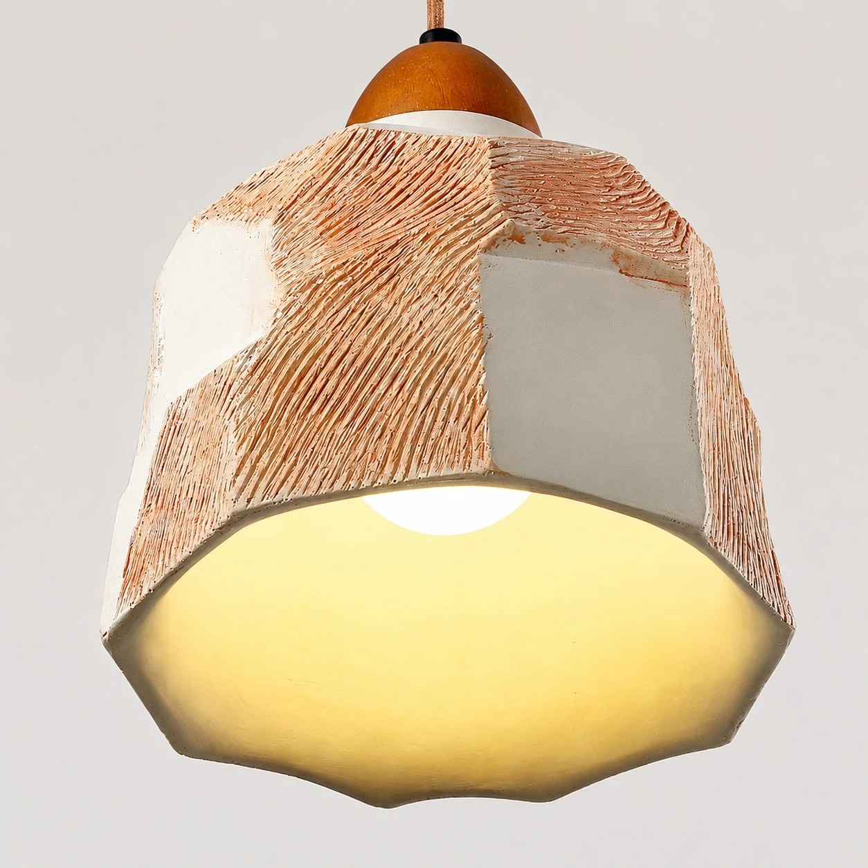 Warm light glow beneath the faceted pendant shade