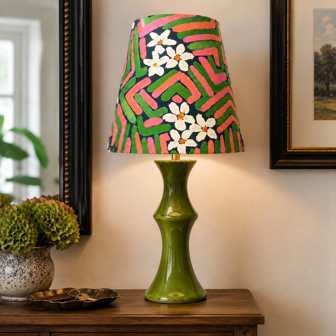 Pink and green fabric shade ceramic table lamp styled on a console