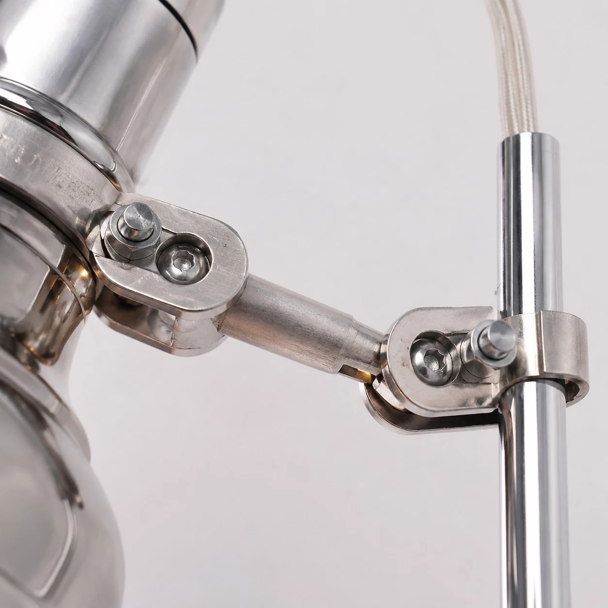 Close-up of the articulated arm joint on the aluminum wall sconce
