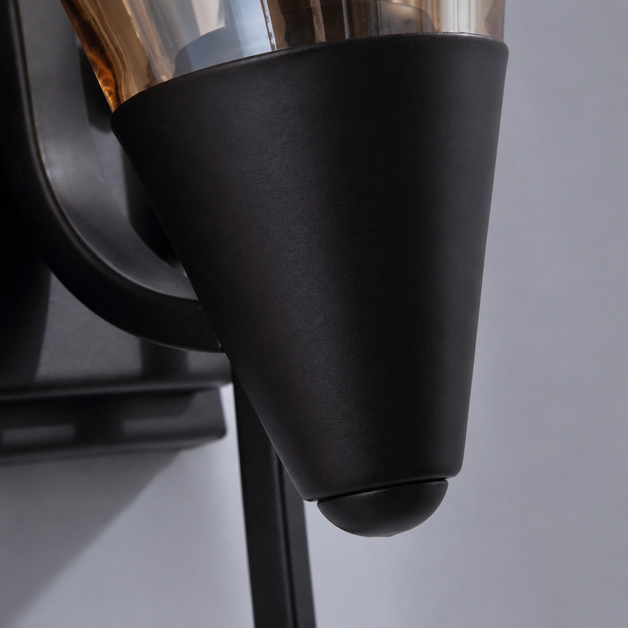 Black metal cup and wall lamp finish detail