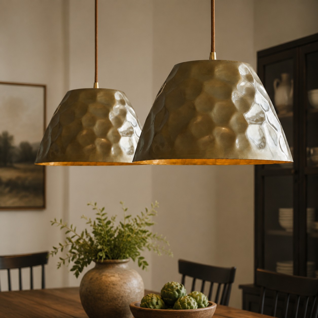 Pair of brass pendant lights above dining table