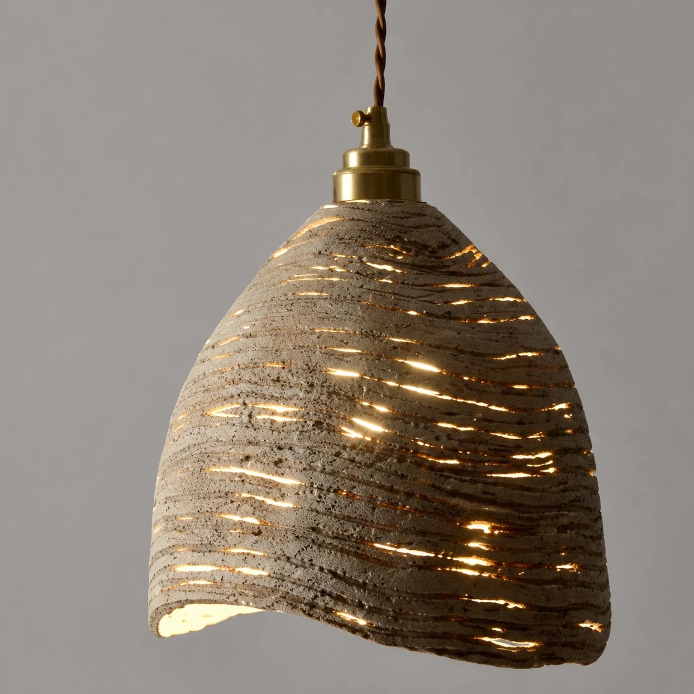 Warm glowing carved wooden pendant shade