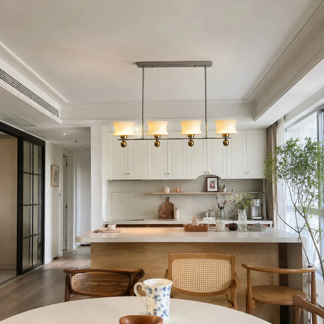 Linear cream glass chandelier above a kitchen island