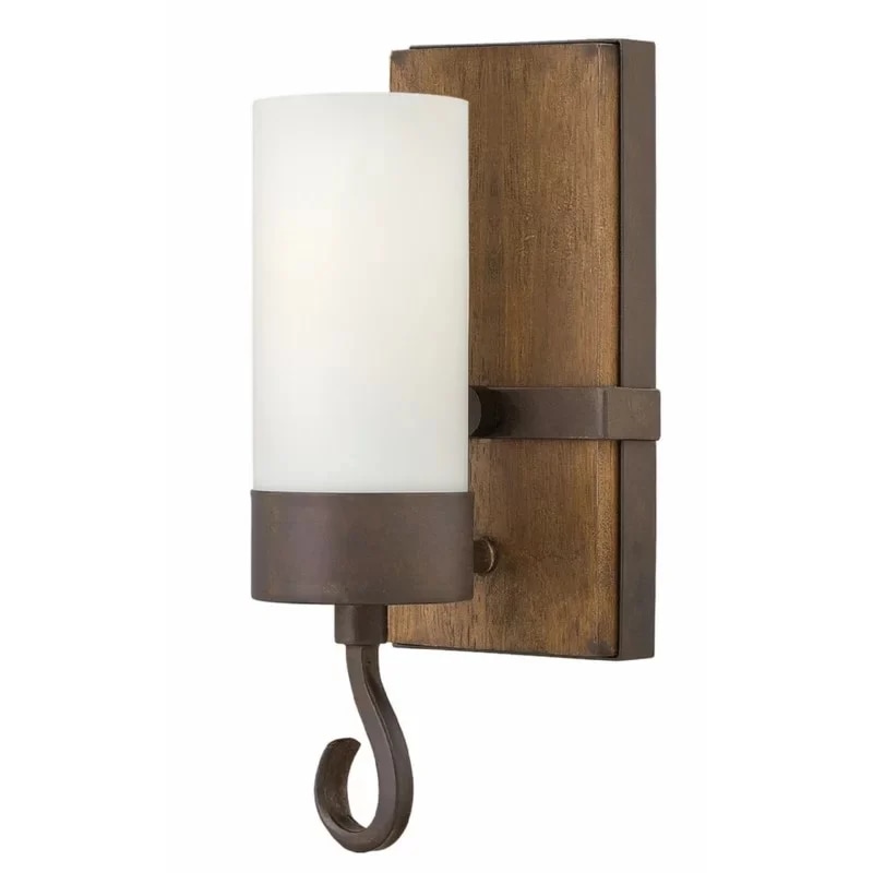 Rustic candle wall sconce with wood backplate, antique dark metal holder, and frosted shade