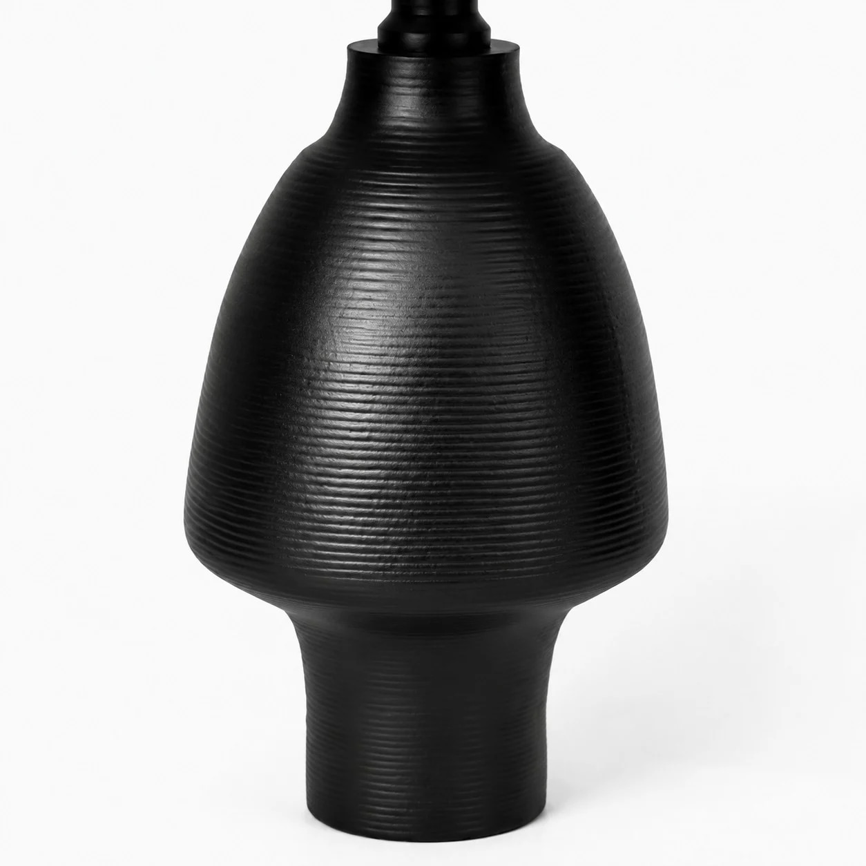 Close detail of black ribbed ceramic lamp base