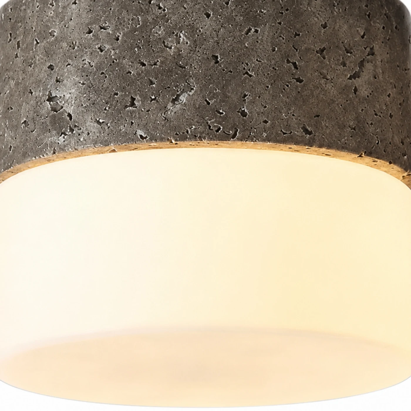 Gray travertine stone texture and warm glass diffuser detail