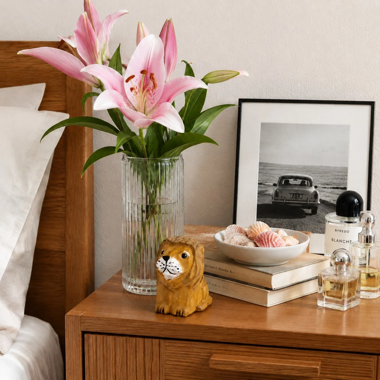 Petite figurine de lion en bois, posée sur une table de chevet.