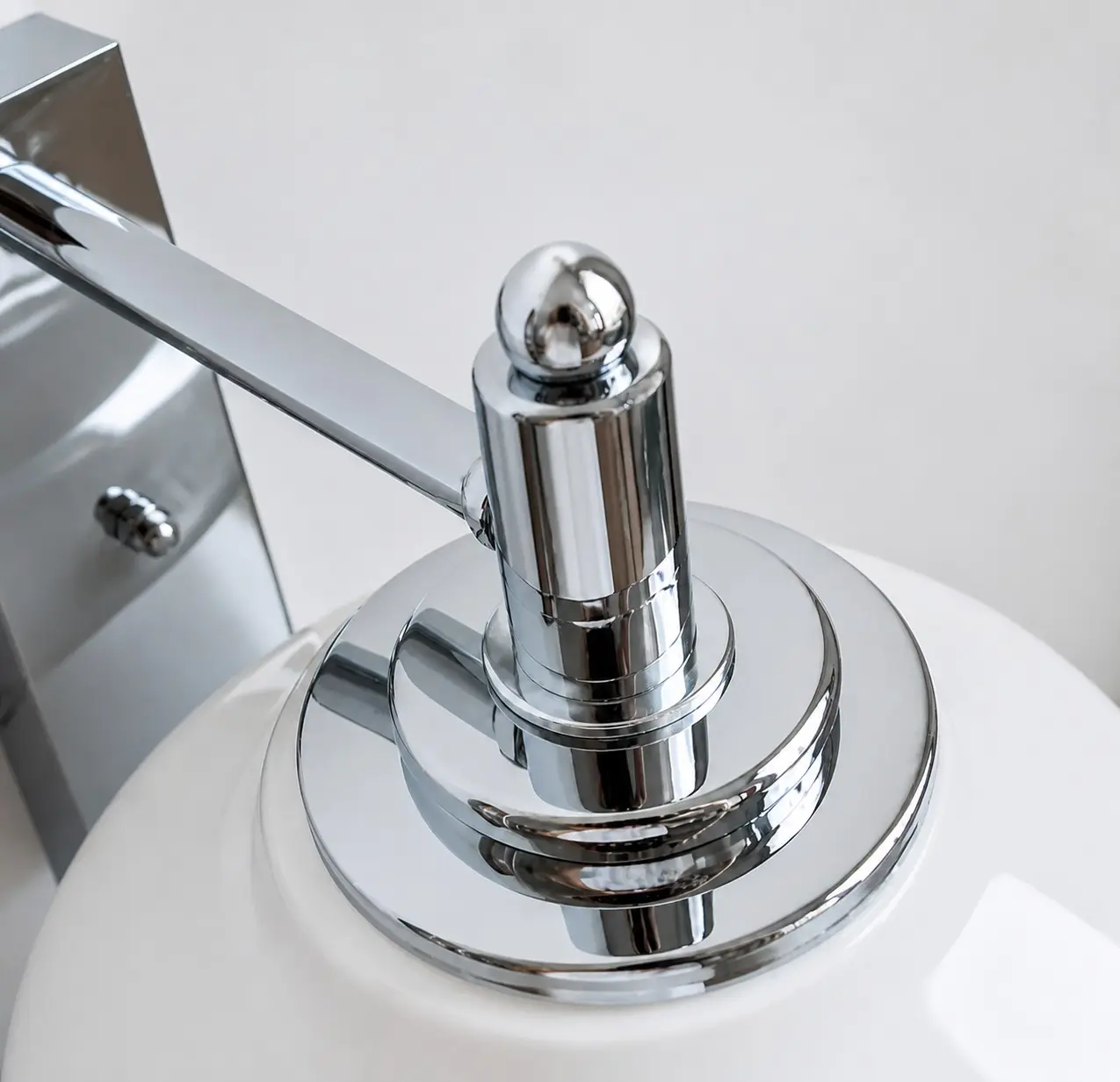 Polished chrome wall mount detail