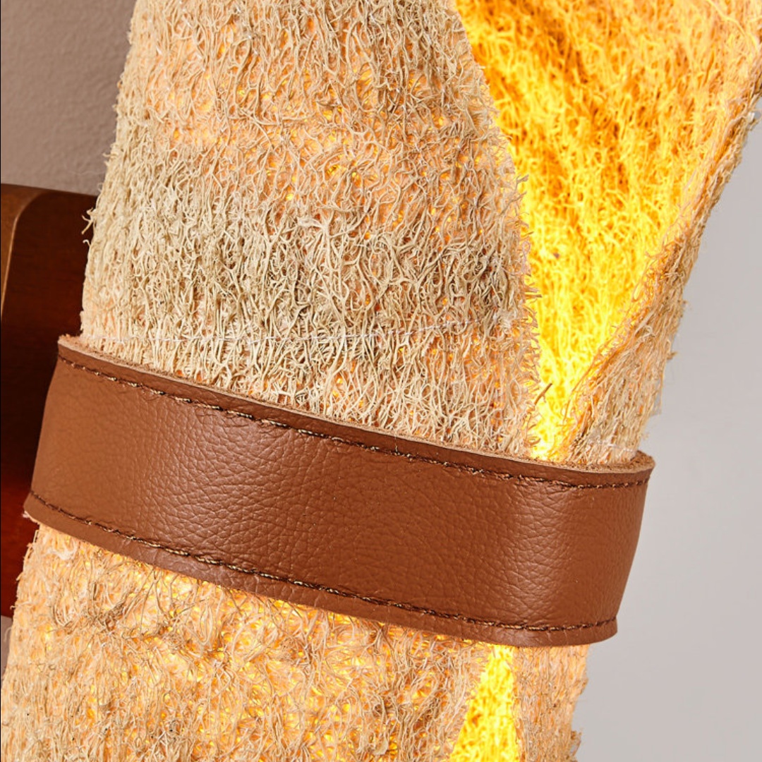 Gros plan sur le bracelet en cuir marron cousu et les fibres de luffa