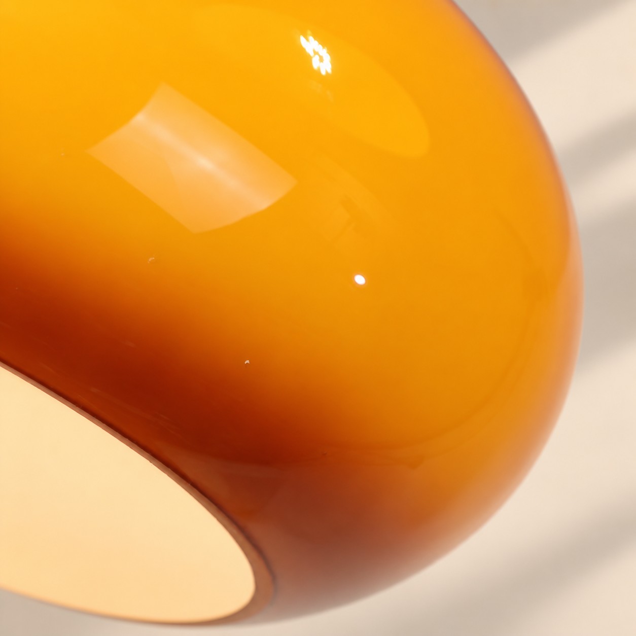 Close-up of glossy orange glass shade