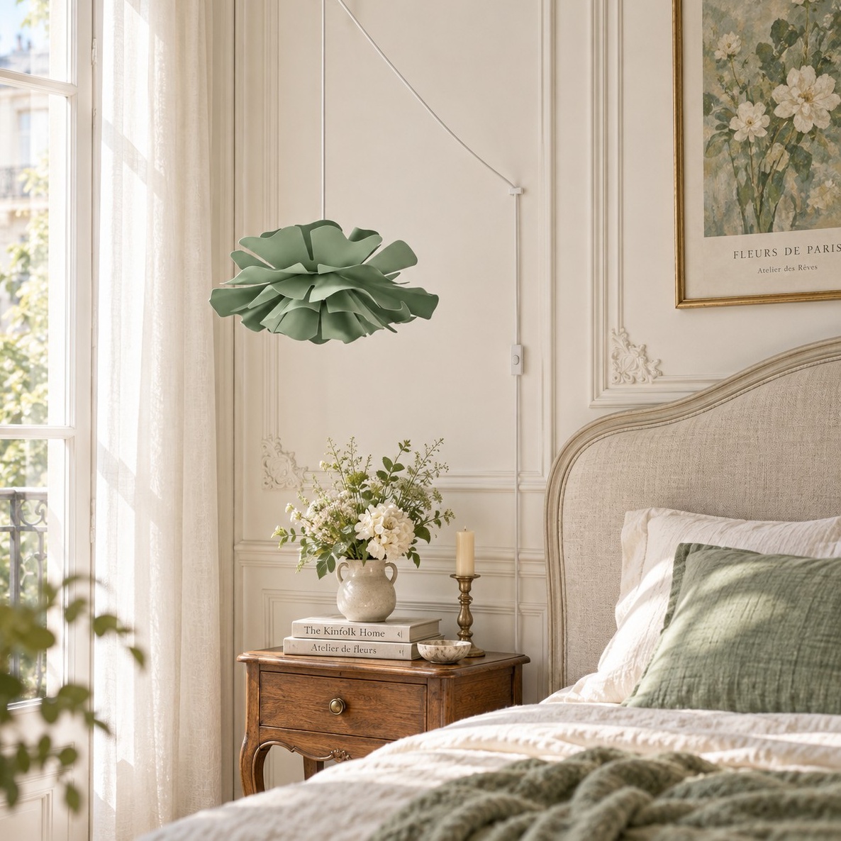 Green floral pendant light beside a bed