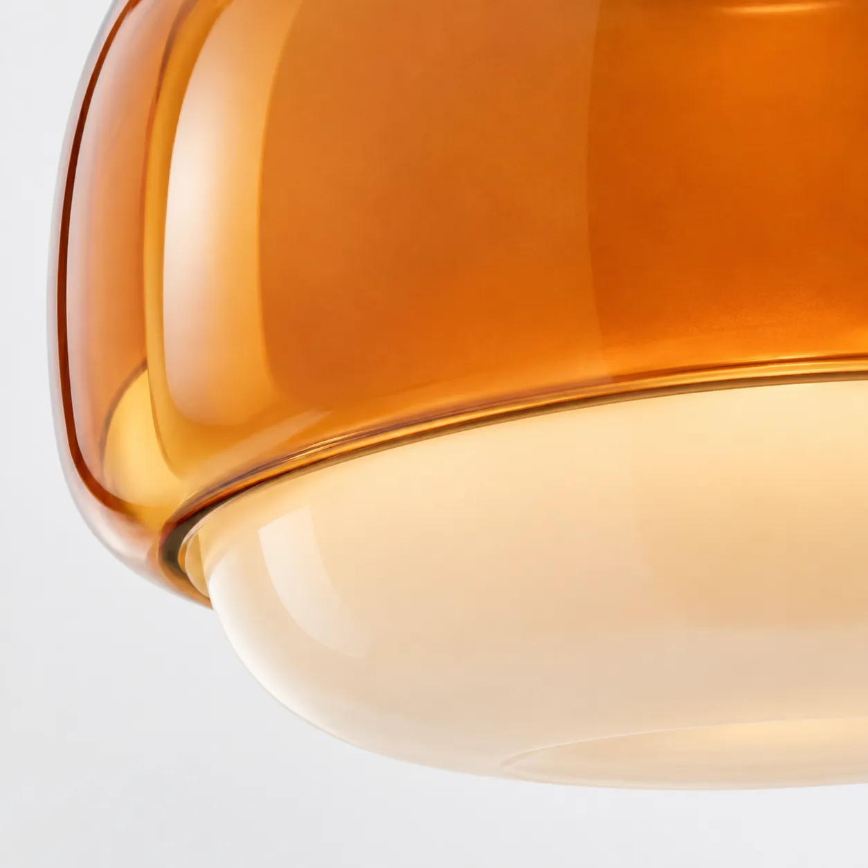 Close detail of the layered amber resin and rounded glass diffuser