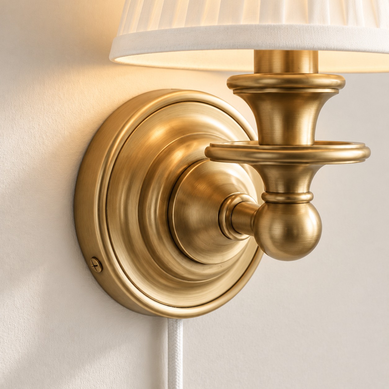 Brushed brass backplate and mounting screw