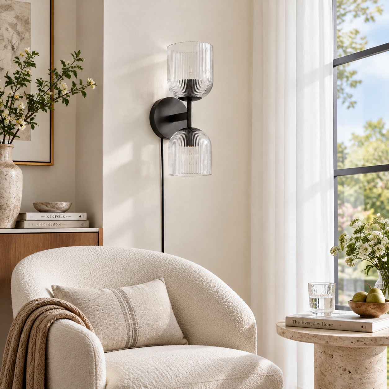 Black two-light ribbed-glass sconce beside a boucle chair