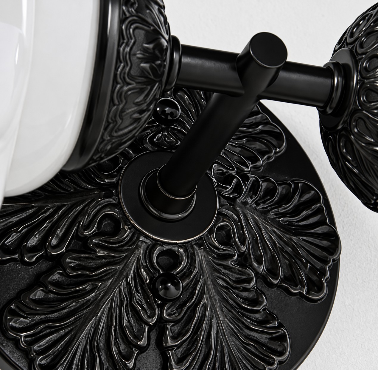 Leaf-relief metal backplate on the Eloise sconce