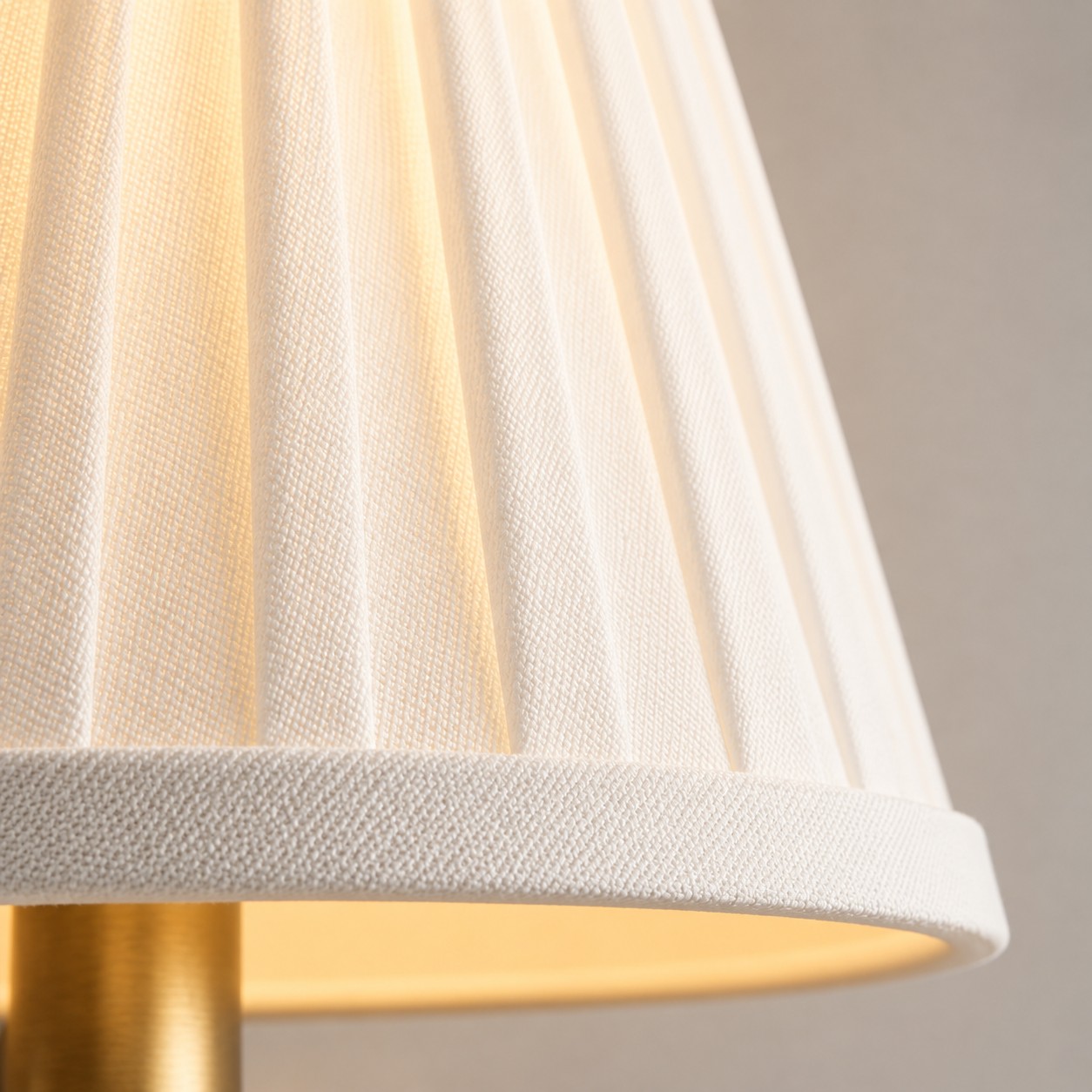 Pleated fabric shade with a warm glow and wrapped hem