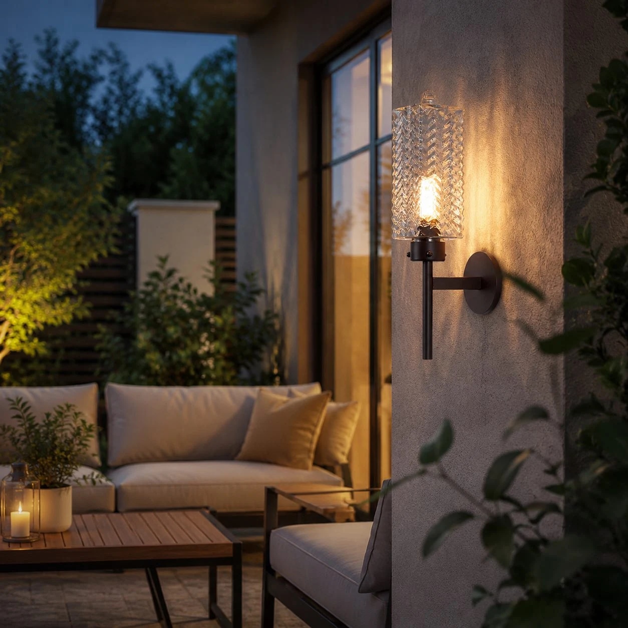 Aplique de pared exterior iluminado junto a los asientos del patio al anochecer.