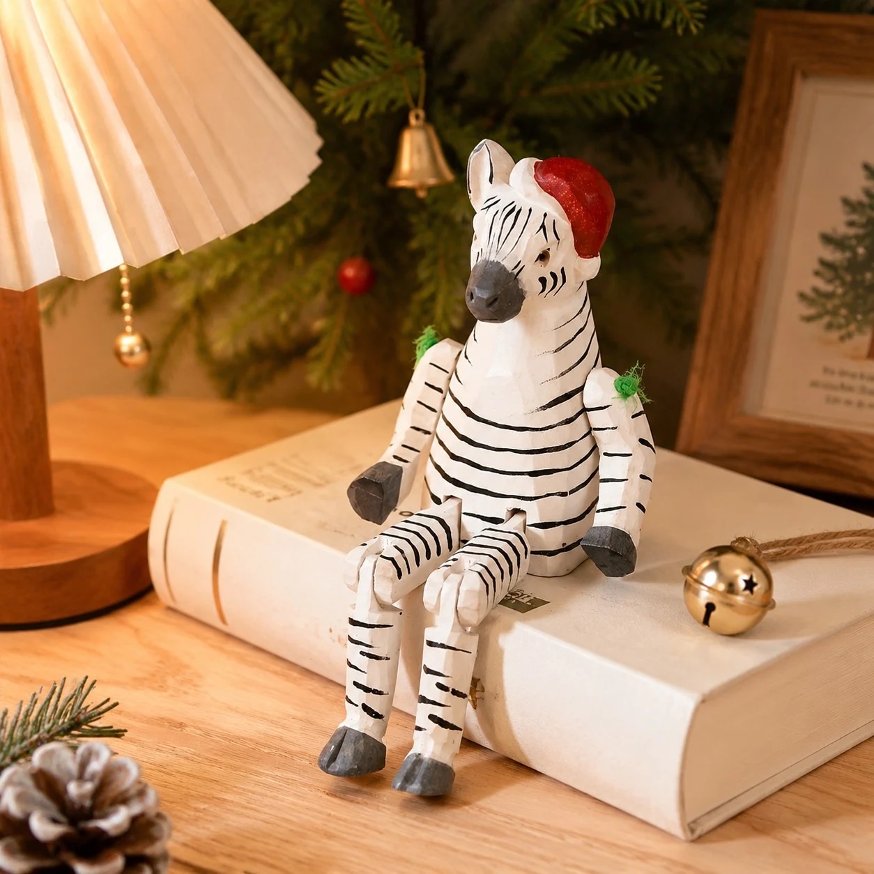 Hand-carved wooden zebra with santa hat ornament styled on a tabletop edge