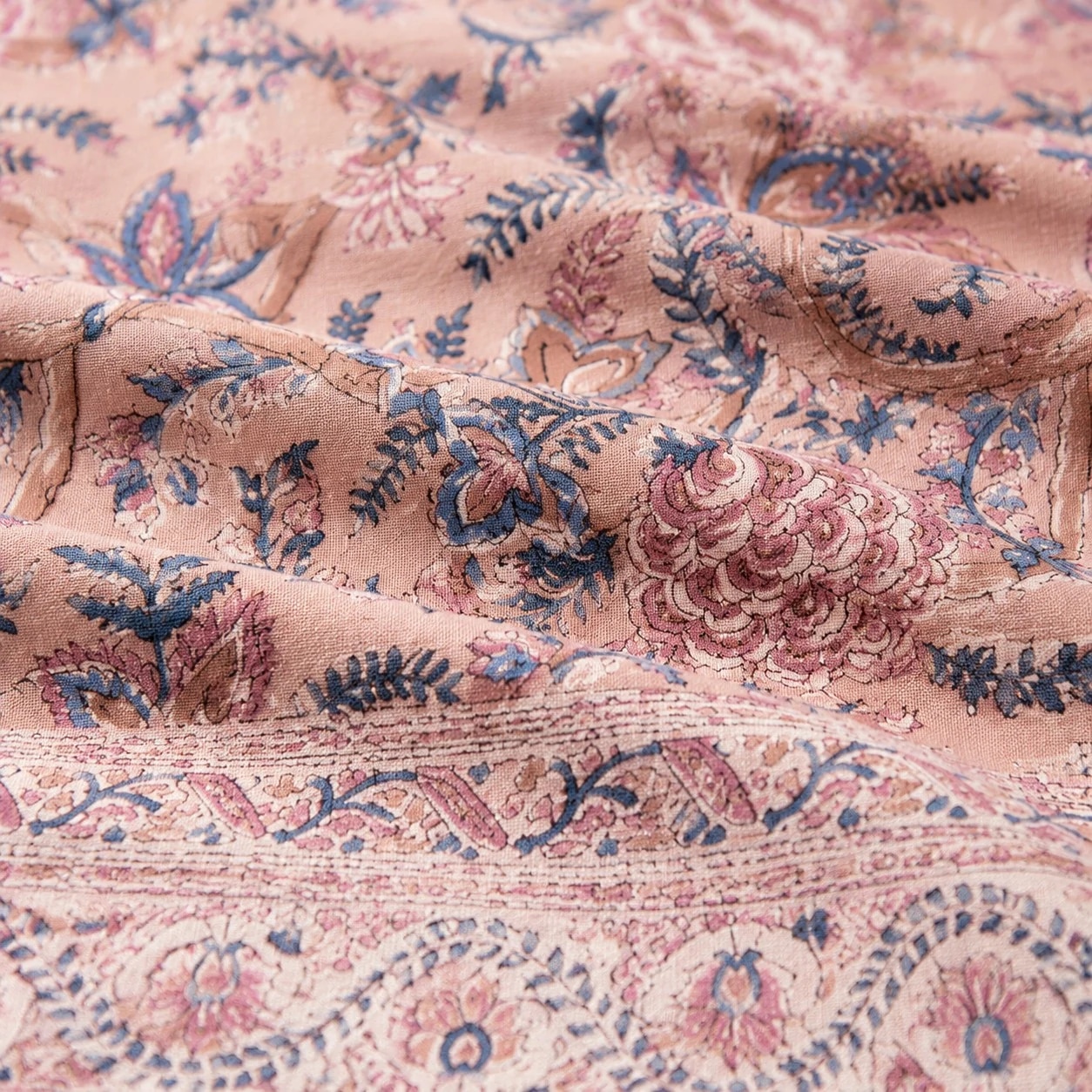 Close detail of rose mauve floral tablecloth fabric texture